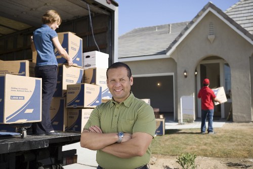 Furniture and boxes being loaded into a removal van