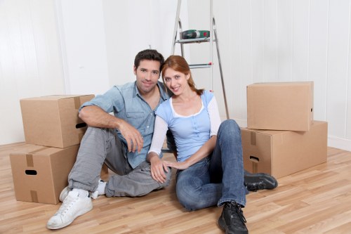Staff using PPE while loading furniture into a van