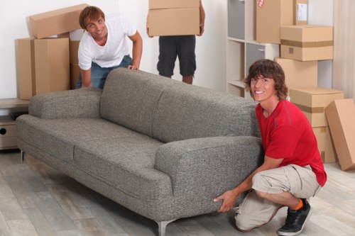 Careful unpacking of household items into a new home in New Malden