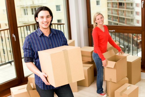 Packed boxes and furniture prepared for urgent removals in a New Malden property